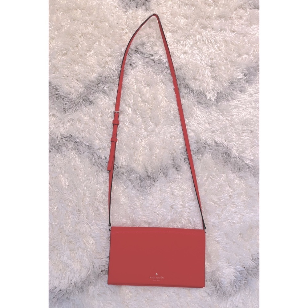 Gently used leather red kate spade purse with black/white polka dot lining